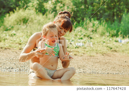 mom and child swim in the river mom and child swim in the river 117647428