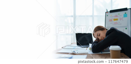 businesswoman plans a finance audit, reviewing documents while battling burnout syndrome. businesswoman plans a finance audit, reviewing documents while battling burnout syndrome. 117647479