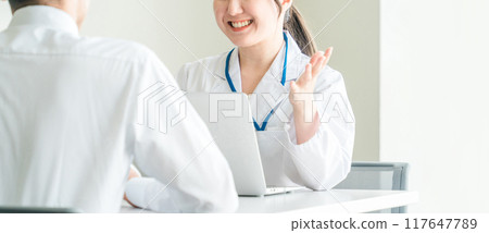 A female doctor explaining something to a patient with a smile (health check, medical examination, medical examination, diagnosis, examination) A female doctor explaining something to a patient with a smile (health check, medical examination, medical examination, diagnosis, examination) 117647789