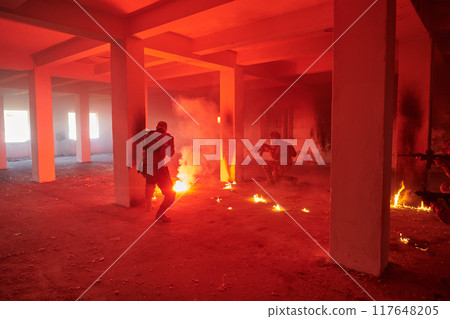 A group of professional soldiers bravely executes a dangerous rescue mission, surrounded by fire in a perilous building. A group of professional soldiers bravely executes a dangerous rescue mission, surrounded by fire in a perilous building. 117648205