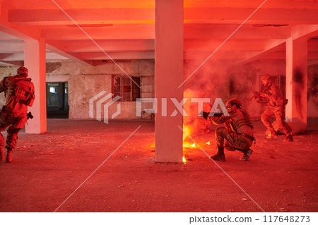 A group of professional soldiers bravely executes a dangerous rescue mission, surrounded by fire in a perilous building. 117648273