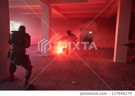 A group of professional soldiers bravely executes a dangerous rescue mission, surrounded by fire in a perilous building. A group of professional soldiers bravely executes a dangerous rescue mission, surrounded by fire in a perilous building. 117648274