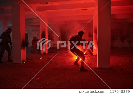 A group of professional soldiers bravely executes a dangerous rescue mission, surrounded by fire in a perilous building. 117648279