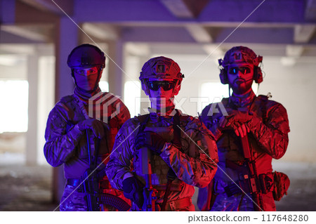 Soldier squad team walking in urban environment colored lightis 117648280