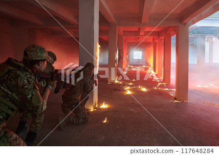 A professional cameraman captures the intense moments as a group of skilled soldiers embarks on a dangerous mission inside an abandoned building, their actions filled with suspense and bravery 117648284