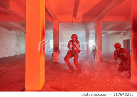 A group of professional soldiers bravely executes a dangerous rescue mission, surrounded by fire in a perilous building. A group of professional soldiers bravely executes a dangerous rescue mission, surrounded by fire in a perilous building. 117648285