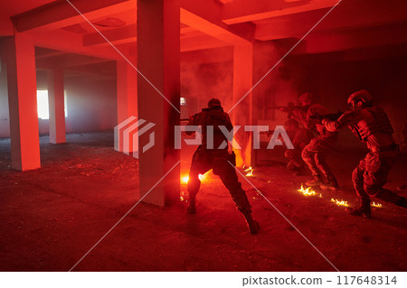 A group of professional soldiers bravely executes a dangerous rescue mission, surrounded by fire in a perilous building. A group of professional soldiers bravely executes a dangerous rescue mission, surrounded by fire in a perilous building. 117648314