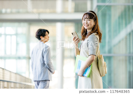 Female college student with smartphone 117648365