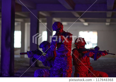 A group of professional soldiers bravely executes a dangerous rescue mission, surrounded by fire in a perilous building. A group of professional soldiers bravely executes a dangerous rescue mission, surrounded by fire in a perilous building. 117648368
