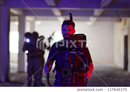 A professional cameraman captures the intense moments as a group of skilled soldiers embarks on a dangerous mission inside an abandoned building, their actions filled with suspense and bravery A professional cameraman captures the intense moments as a group of skilled soldiers embarks on a dangerous mission inside an abandoned building, their actions filled with suspense and bravery 117648370