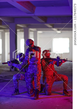 A group of professional soldiers bravely executes a dangerous rescue mission, surrounded by fire in a perilous building. 117648373