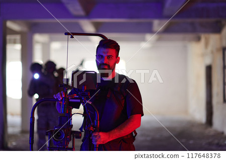 A professional cameraman captures the intense moments as a group of skilled soldiers embarks on a dangerous mission inside an abandoned building, their actions filled with suspense and bravery 117648378