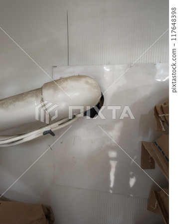 A rat's entry point through a gap in a pipe 117648398