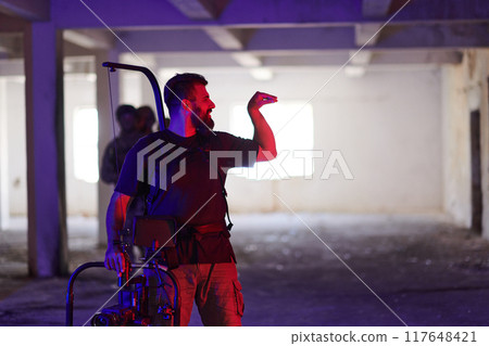 A professional cameraman captures the intense moments as a group of skilled soldiers embarks on a dangerous mission inside an abandoned building, their actions filled with suspense and bravery A professional cameraman captures the intense moments as a group of skilled soldiers embarks on a dangerous mission inside an abandoned building, their actions filled with suspense and bravery 117648421