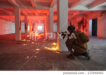 A group of professional soldiers bravely executes a dangerous rescue mission, surrounded by fire in a perilous building. 117648491