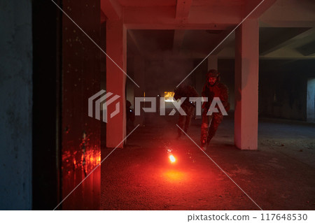 A group of professional soldiers bravely executes a dangerous rescue mission, surrounded by fire in a perilous building. A group of professional soldiers bravely executes a dangerous rescue mission, surrounded by fire in a perilous building. 117648530