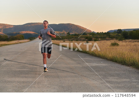 A young handsome man running in the early morning hours, driven by his commitment to health and fitness 117648594