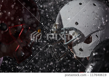 Two american football players face to face in silhouette shadow on white background Two american football players face to face in silhouette shadow on white background 117648619