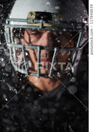 American Football Field: Lonely Athlete Warrior Standing on a Field Holds his Helmet and Ready to Play. Player Preparing to Run, Attack and Score Touchdown. Rainy Night with Dramatic Fog, Blue Light American Football Field: Lonely Athlete Warrior Standing on a Field Holds his Helmet and Ready to Play. Player Preparing to Run, Attack and Score Touchdown. Rainy Night with Dramatic Fog, Blue Light 117648639