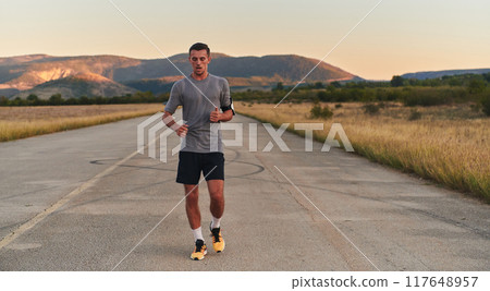 A young handsome man running in the early morning hours, driven by his commitment to health and fitness 117648957