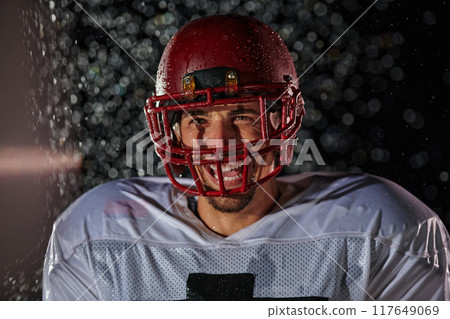 American Football Field: Lonely Athlete Warrior Standing on a Field Holds his Helmet and Ready to Play. Player Preparing to Run, Attack and Score Touchdown. Rainy Night with Dramatic Fog, Blue Light American Football Field: Lonely Athlete Warrior Standing on a Field Holds his Helmet and Ready to Play. Player Preparing to Run, Attack and Score Touchdown. Rainy Night with Dramatic Fog, Blue Light 117649069