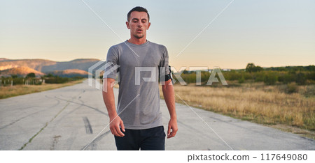 A young handsome man running in the early morning hours, driven by his commitment to health and fitness A young handsome man running in the early morning hours, driven by his commitment to health and fitness 117649080
