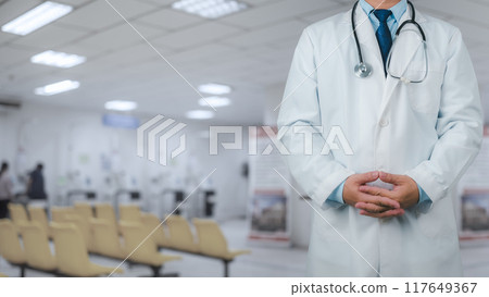 Doctor in a lab coat is standing on the background inside a hospital, Medical concept, Medical information search, Concept of treating disease. Insurance concept, Concept for commercial business. Doctor in a lab coat is standing on the background inside a hospital, Medical concept, Medical information search, Concept of treating disease. Insurance concept, Concept for commercial business. 117649367
