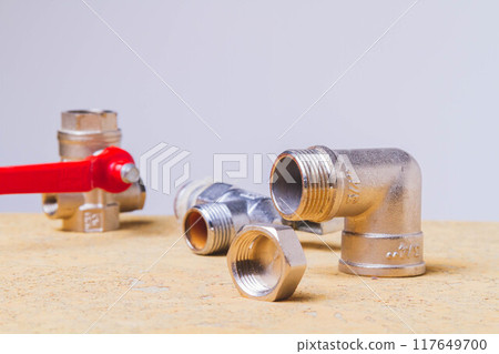 A water tap and a hose in a metal braid. Accessories for the repair of water supply. 117649700