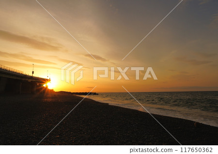 Sunrise on the coastline along which the expressway runs 117650362