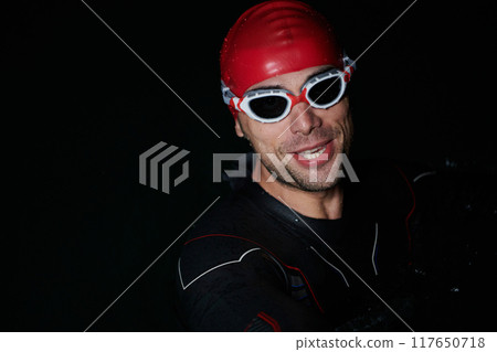 A triathlete finds serene rejuvenation in a lake, basking in the tranquility of the water after an intense training session A triathlete finds serene rejuvenation in a lake, basking in the tranquility of the water after an intense training session 117650718