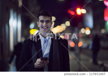 Smiling Meedle Eastern man walking down street near modern office building, Smiling Meedle Eastern man walking down street near modern office building, 117651007