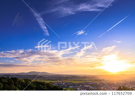 Evening view from a hill overlooking the town of Kizu in Kizugawa City, the southernmost part of Kyoto Prefecture. The sun sets over the Ikoma mountain range, painting the mountainside golden #17 Evening view from a hill overlooking the town of Kizu in Kizugawa City, the southernmost part of Kyoto Prefecture. The sun sets over the Ikoma mountain range, painting the mountainside golden #17 117652709