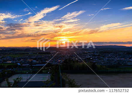 Evening view from a hill overlooking the town of Kizu in Kizugawa City, the southernmost part of Kyoto Prefecture. The sun sets over the Ikoma mountain range, painting the mountainside golden #33 117652732