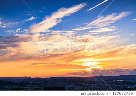 Evening view from a hill overlooking the town of Kizu in Kizugawa City, the southernmost part of Kyoto Prefecture. The sun sets over the Ikoma mountain range, painting the mountainside golden #39 Evening view from a hill overlooking the town of Kizu in Kizugawa City, the southernmost part of Kyoto Prefecture. The sun sets over the Ikoma mountain range, painting the mountainside golden #39 117652739