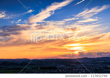 Evening view from a hill overlooking the town of Kizu in Kizugawa City, the southernmost part of Kyoto Prefecture. The sun sets over the Ikoma mountain range, painting the mountainside golden #40 117652740