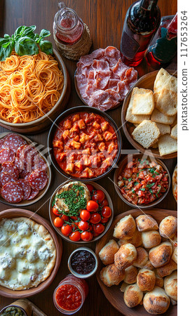 A top-down view of a full table spread with a variety of classic Italian dishes A top-down view of a full table spread with a variety of classic Italian dishes 117653264