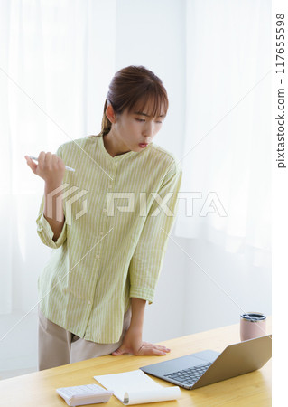Young woman preparing to start a business in the office 117655598