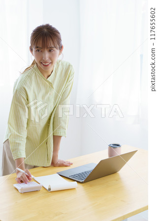 Young woman preparing to start a business in the office 117655602