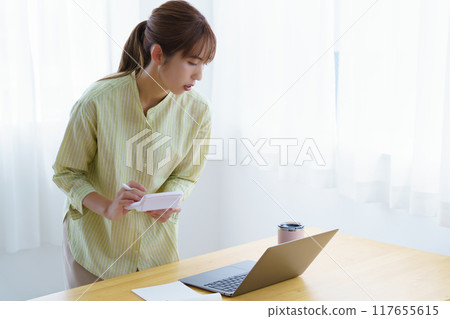 Young woman preparing to start a business in the office Young woman preparing to start a business in the office 117655615