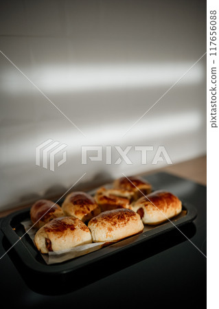 Freshly baked rolls cooling on a kitchen countertop in soft morning light Freshly baked rolls cooling on a kitchen countertop in soft morning light 117656088