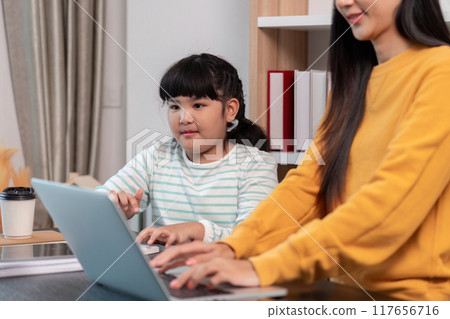 Mother and daughter bonding over shared laptop activities Mother and daughter bonding over shared laptop activities 117656716