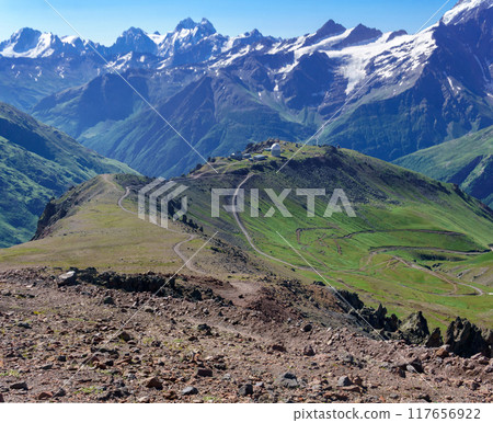 mountain landscape with observatory in the distance and mountain peaks in the background mountain landscape with observatory in the distance and mountain peaks in the background 117656922