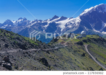 mountain landscape with observatory in the distance and mountain peaks in the background mountain landscape with observatory in the distance and mountain peaks in the background 117656982