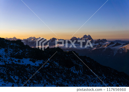 mountain peaks in the rays of early morning dawn, panoramic natural landscape mountain peaks in the rays of early morning dawn, panoramic natural landscape 117656988