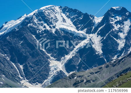 mountain landscape, view of Mount Donguzorun with snowfields and glaciers 117656996
