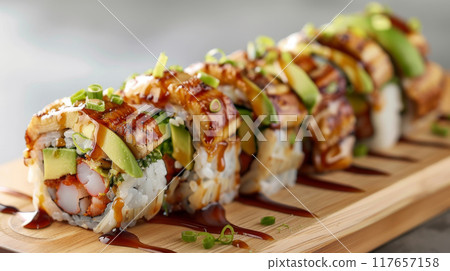Experience the artistry of Dragon rolls, a gourmet delight that combines the delicate flavors of shrimp tempura, crisp cucumber, and creamy avocado wrapped in sushi rice and seaweed 117657158
