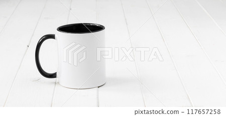 white cup with black handle and inside white cup with black handle and inside 117657258