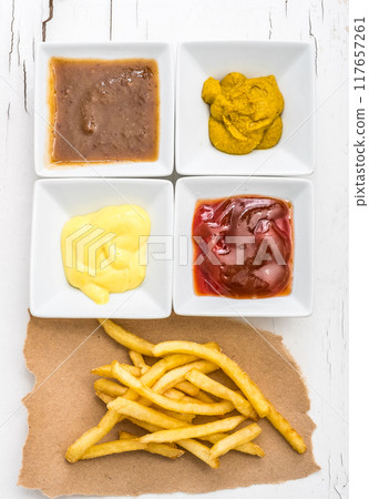 French fries with sauces on white background, top view French fries with sauces on white background, top view 117657261
