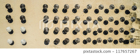 wooden sunshade umbrellas on a beach 117657267