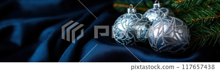 Three silver ornaments are on a blue background Three silver ornaments are on a blue background 117657438